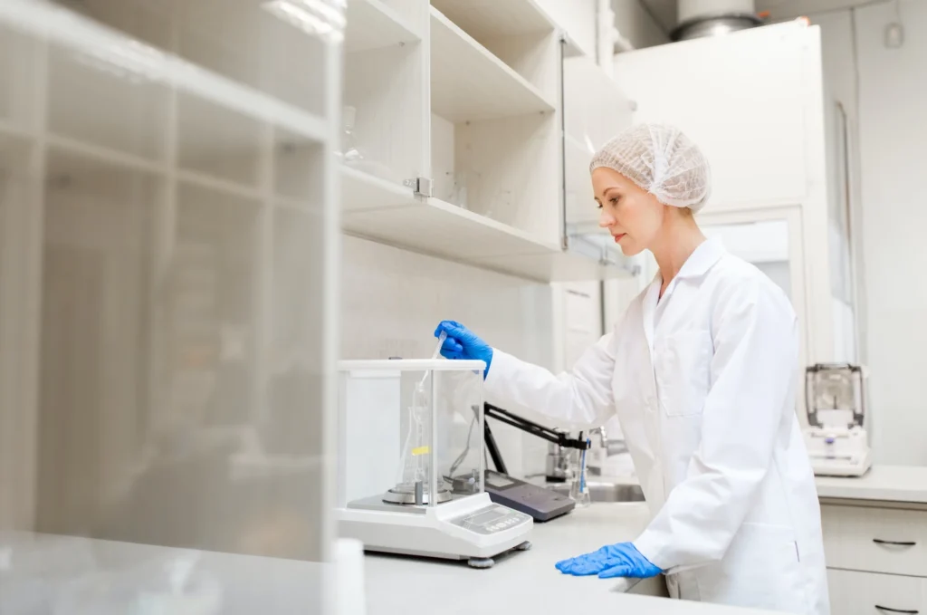 Woman-with-sulphuric-acid-and-scale-at-laboratory